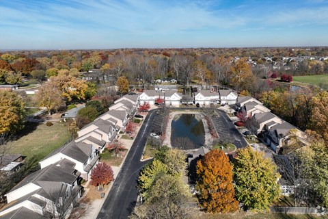 A suburban neighborhood with houses and a pond.