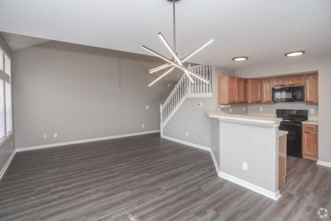 A modern kitchen with wooden cabinets and a stainless steel oven.