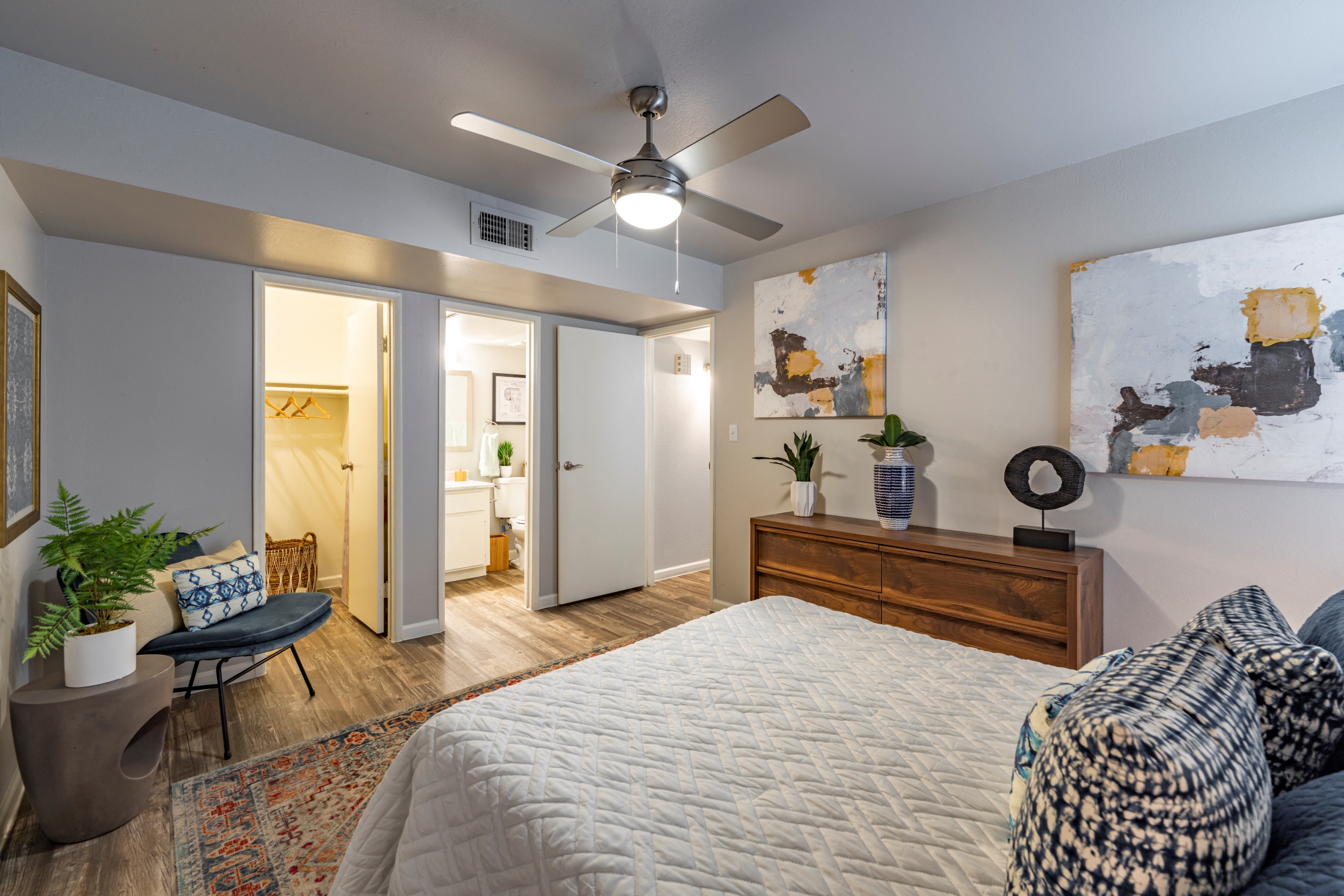 a bedroom with a large bed and a ceiling fan