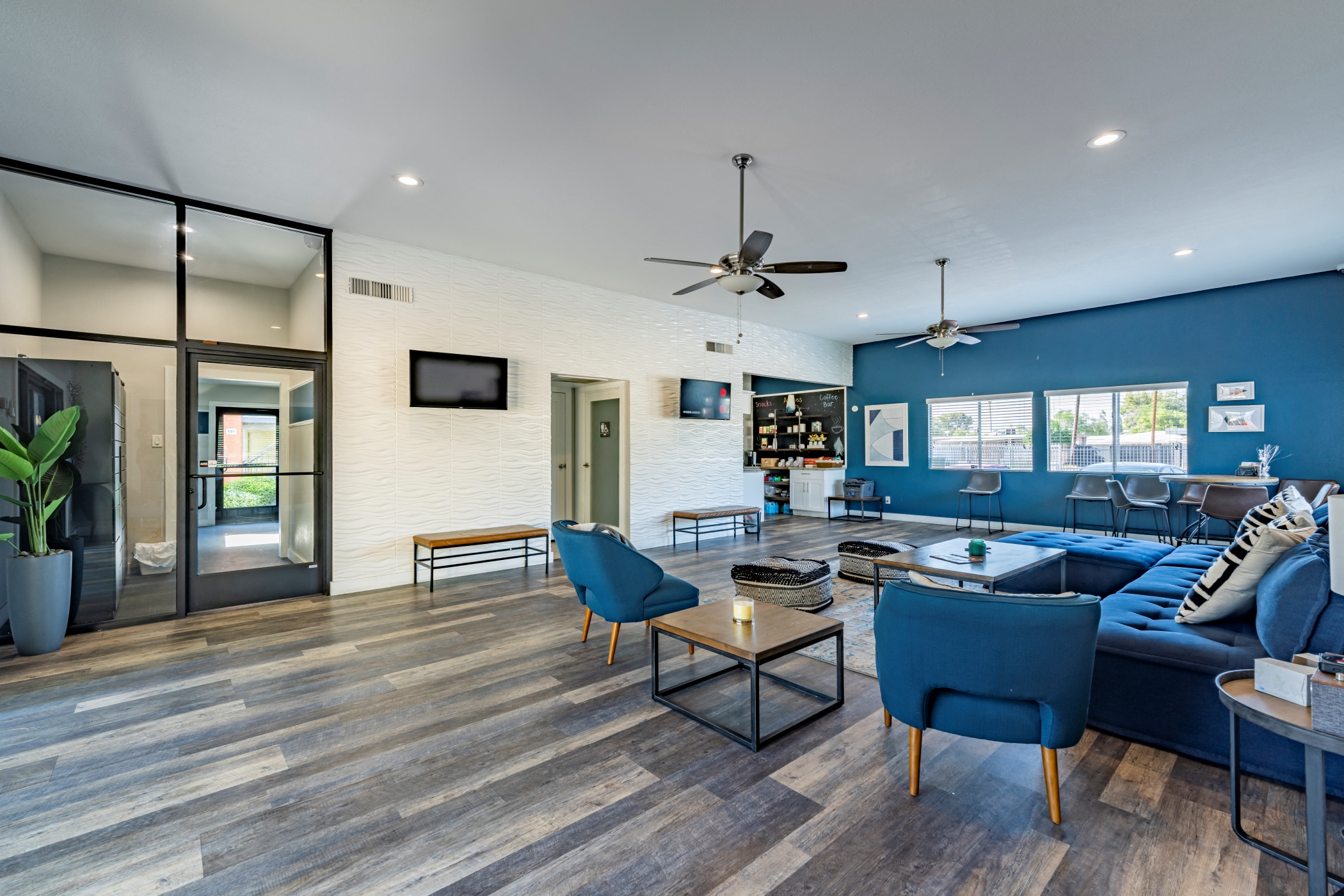 a living room with blue chairs and a blue couch