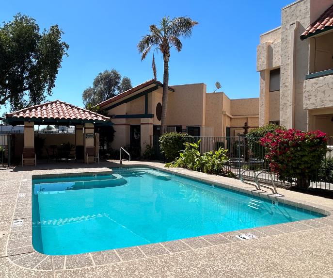 a large swimming pool in front of a building