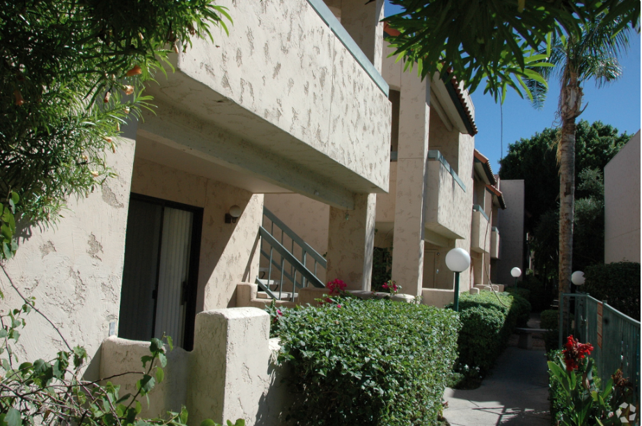 the outside of a building with a staircase and plants