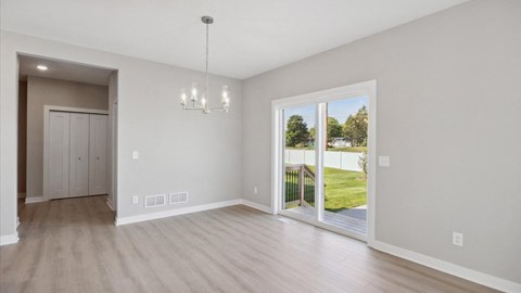 a living room with a large window and a door to a backyard