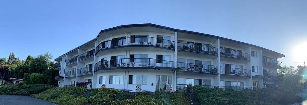 a building with many balconies on a hill