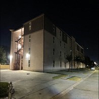 a building on the corner of a street at night
