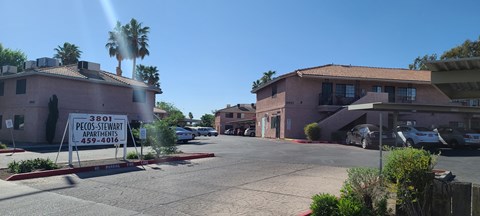 a real estate sign sits in front of a building