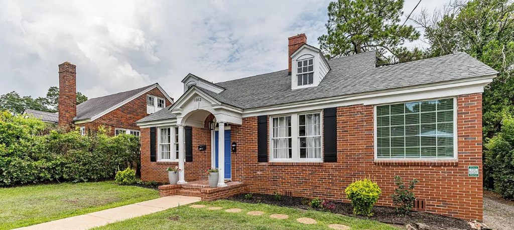 a brick house with a blue front door