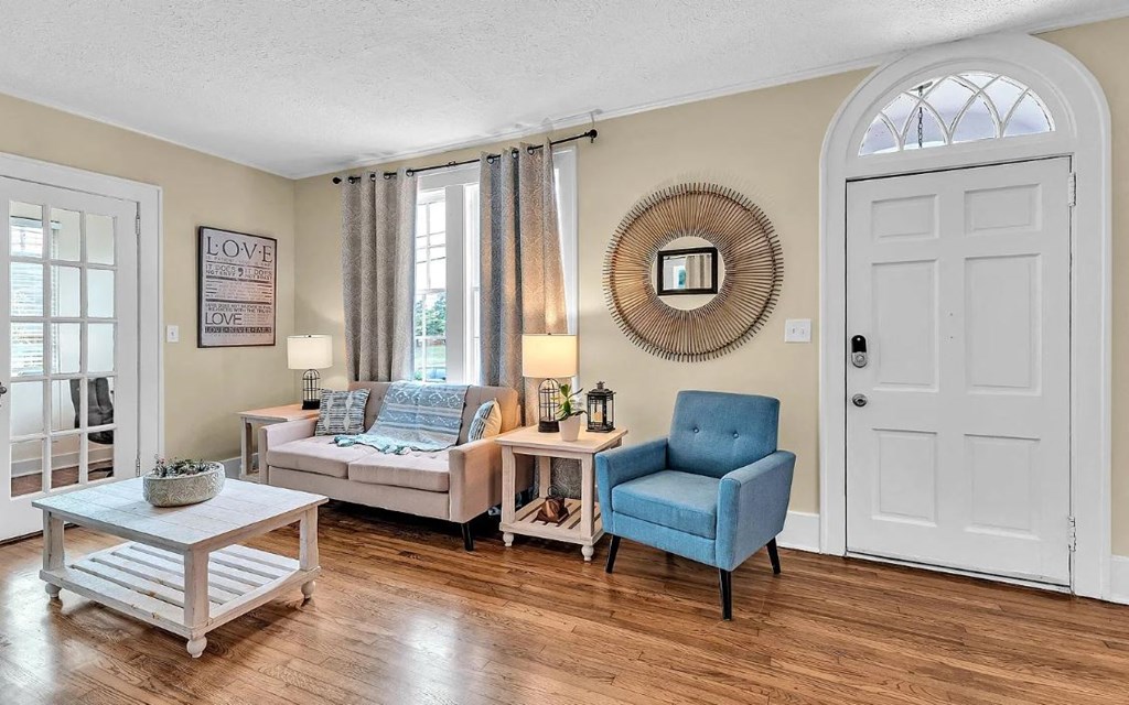 a living room with a white door and furniture