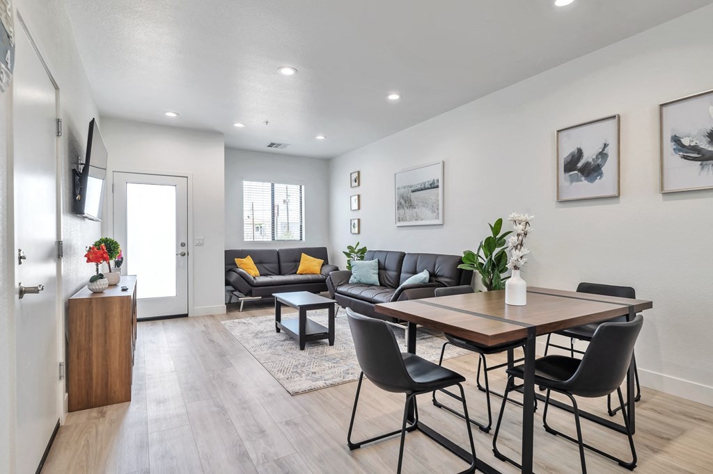 a living room with a dining room table and a couch