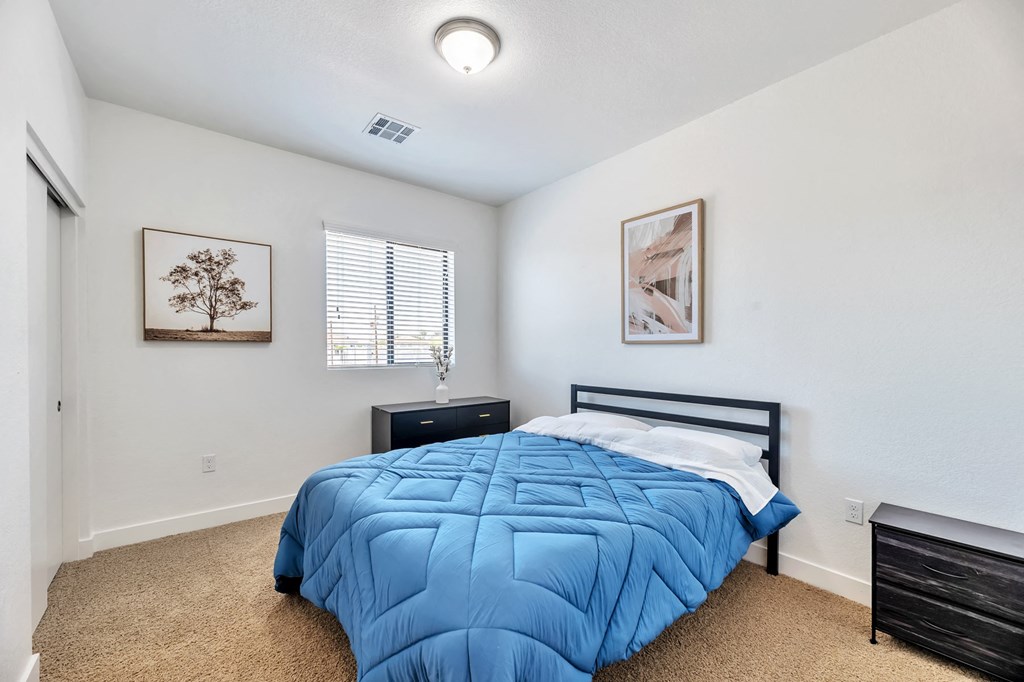 a bedroom with a bed and a window