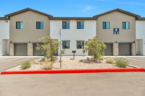 a building with three garages and a flag in front of it