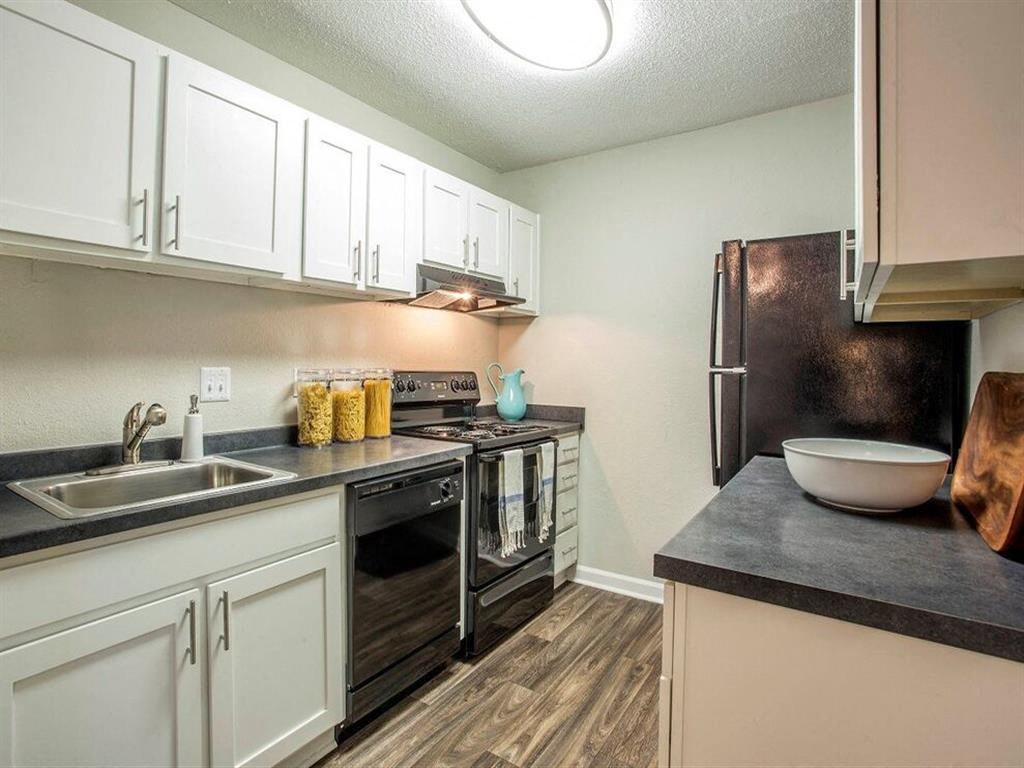 a kitchen with stainless steel appliances and white cabinets