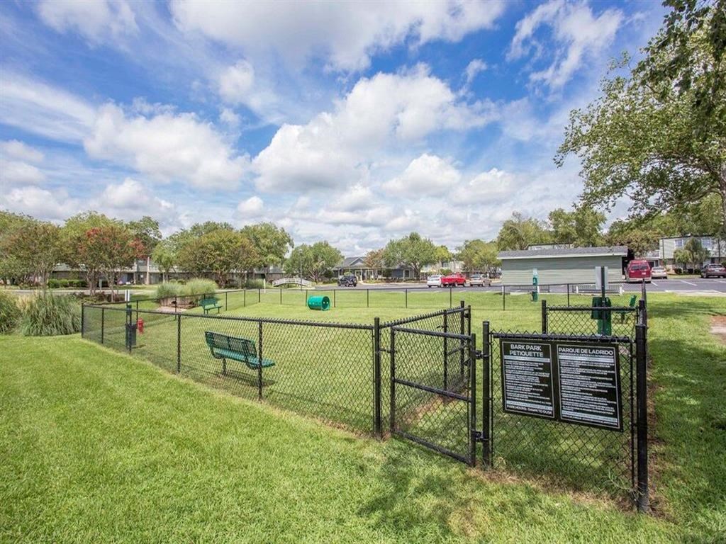 a dog park with a fence and benches