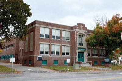 a red brick building on the corner of a street