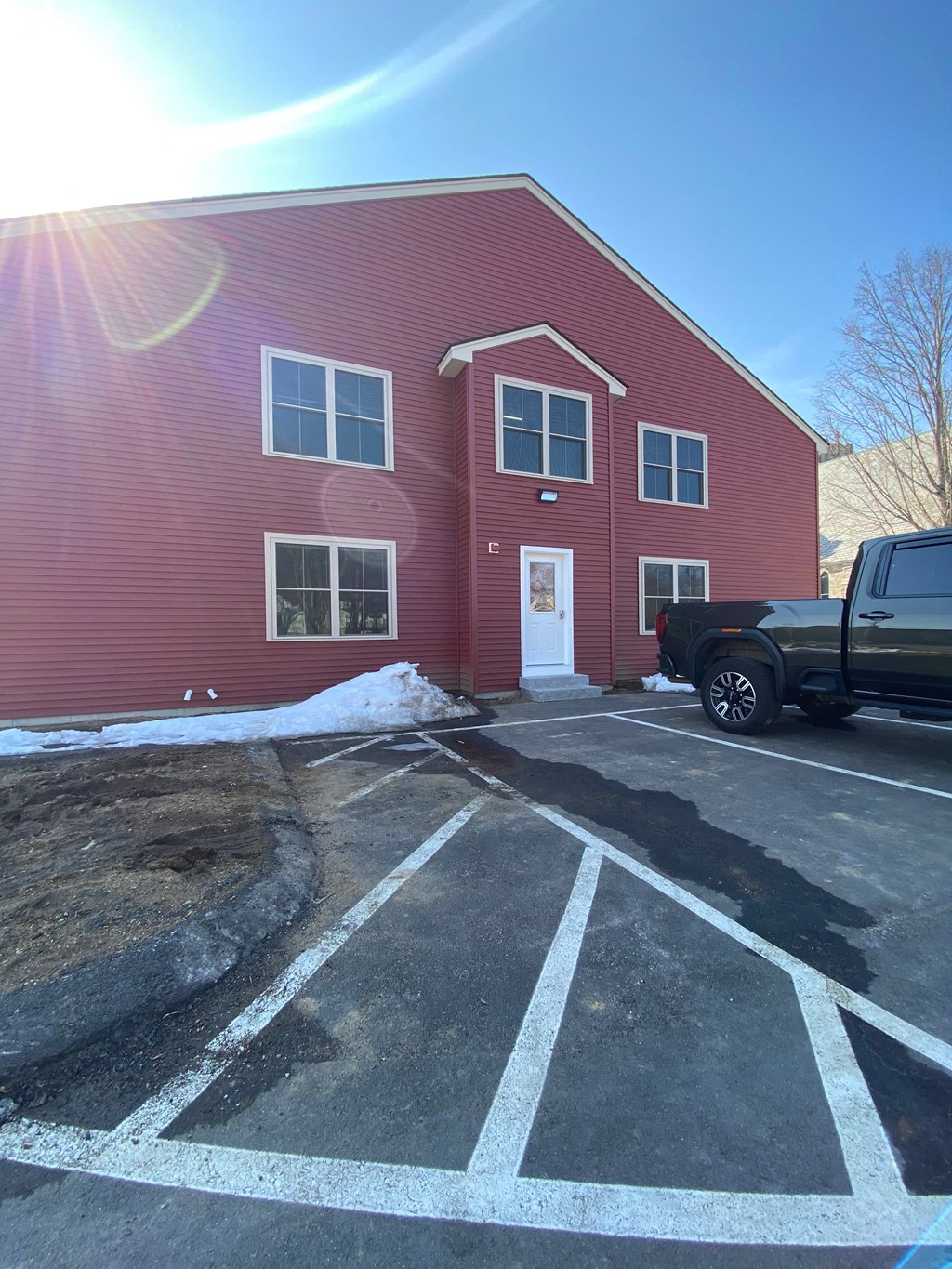 a red building with a truck parked in front of it