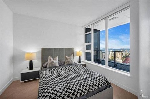a bedroom with a bed and a large window
