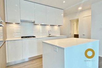 a white kitchen with white cabinets and a white counter top