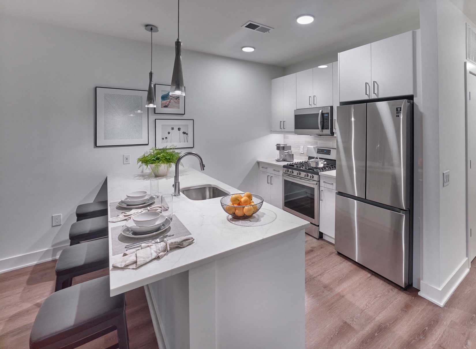 a kitchen with stainless steel appliances and a white counter top