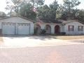 a house with a garage and a driveway in front of it