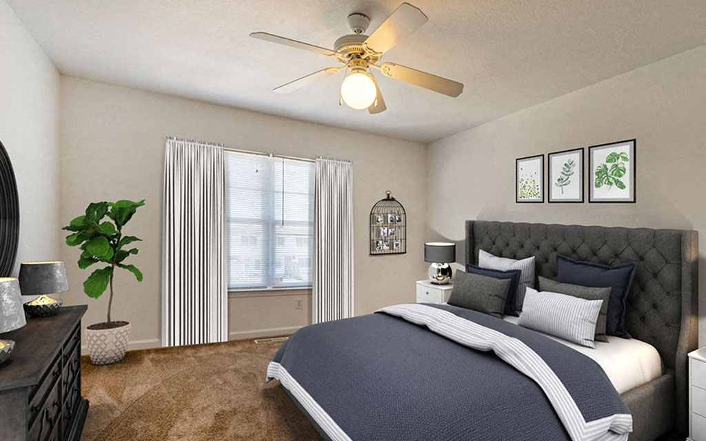 a bedroom with a bed and a ceiling fan