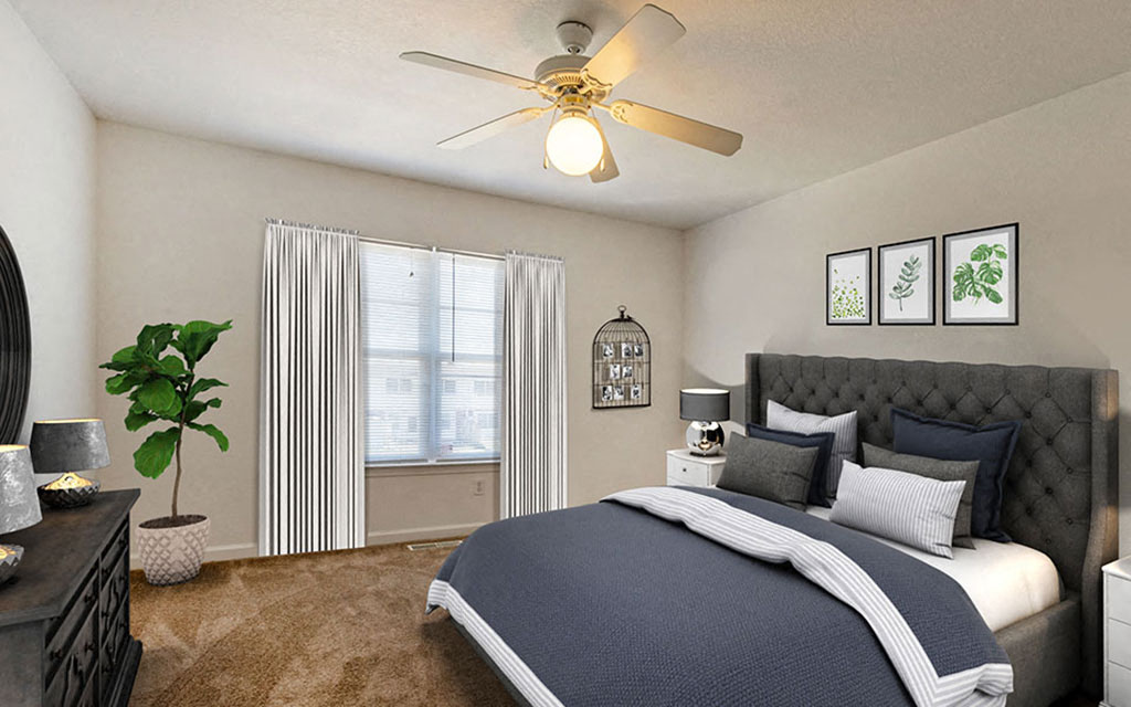 a bedroom with a bed and a ceiling fan