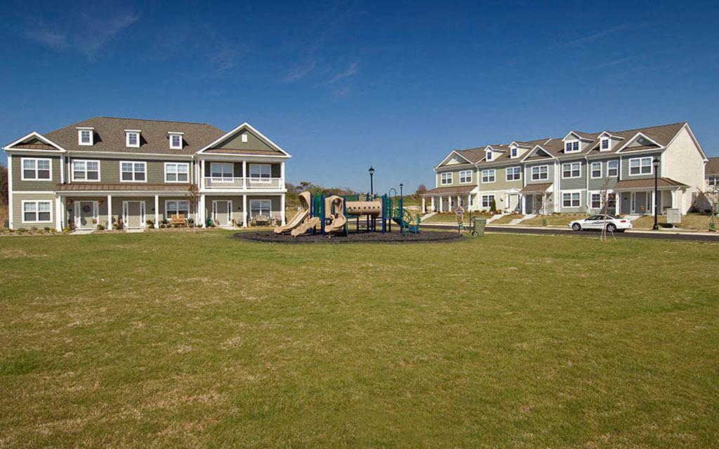 a playground in front of a row of houses