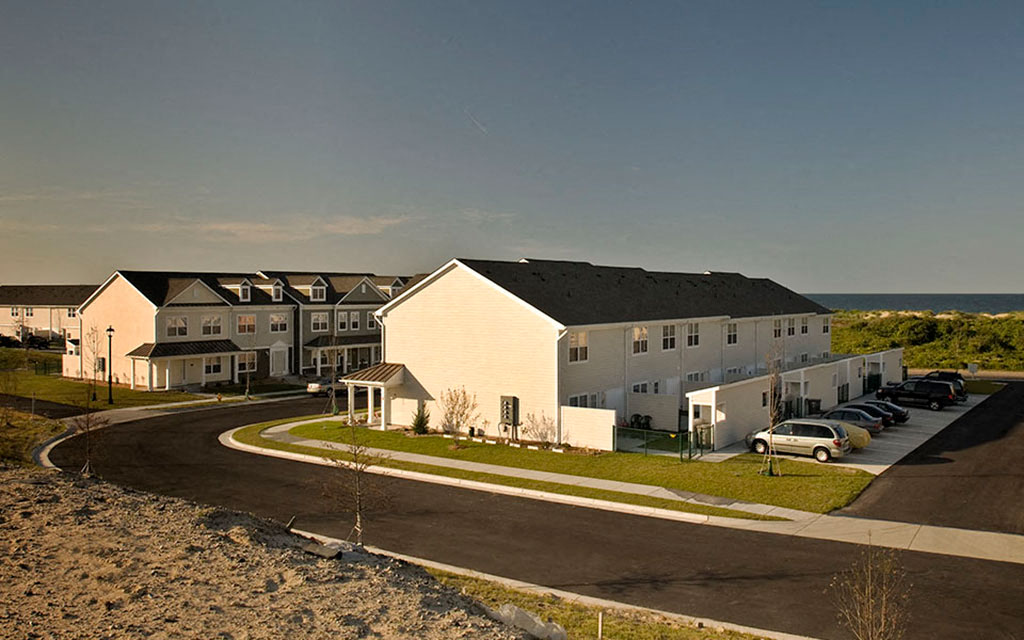 a row of houses on a street near the beach