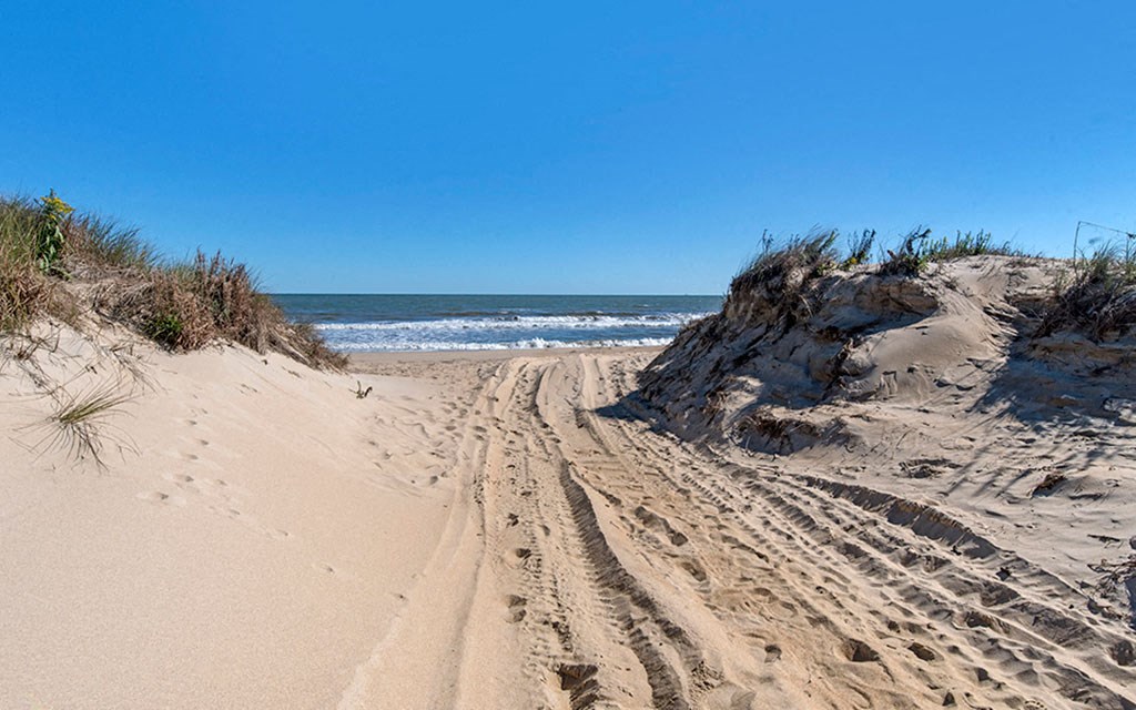 a path through the sand to the beach
