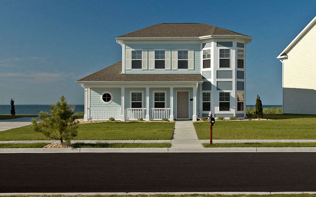 a house on the side of the street with a sidewalk