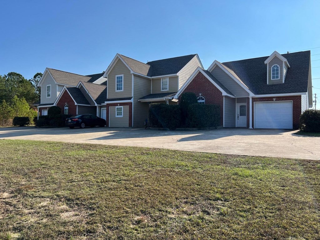 a house with a driveway and a car in front of it