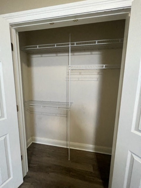 an empty closet with empty shelves and a door