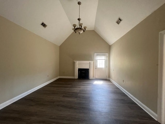 a large empty room with wood floors and a fireplace