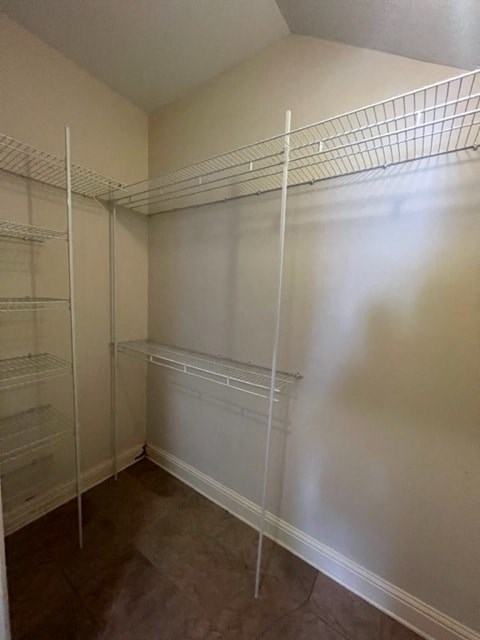 a large walk in closet with empty shelves