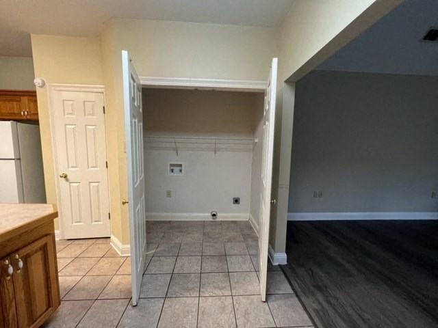 an empty kitchen and living room with an open door