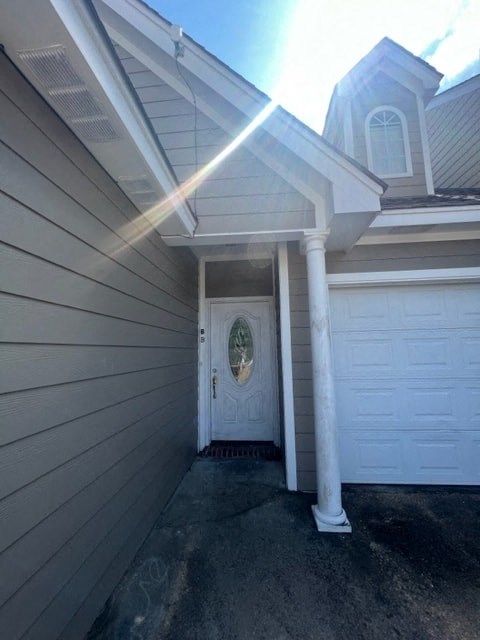 a white garage door on the side of a house