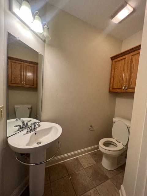 a bathroom with a toilet and a sink and a mirror