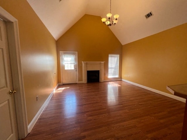 an empty living room with wooden floors and a fireplace