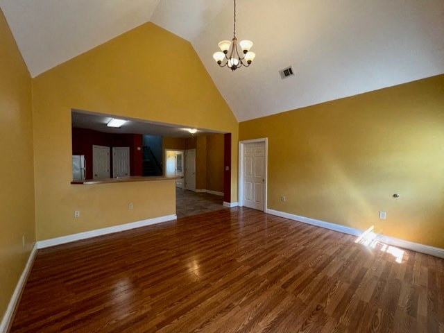 an empty living room with yellow walls and a wood floor