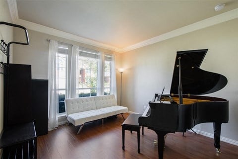 a living room with a piano and a couch