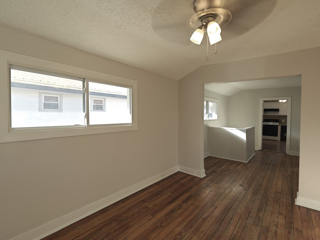 A room with wooden floors and a window.