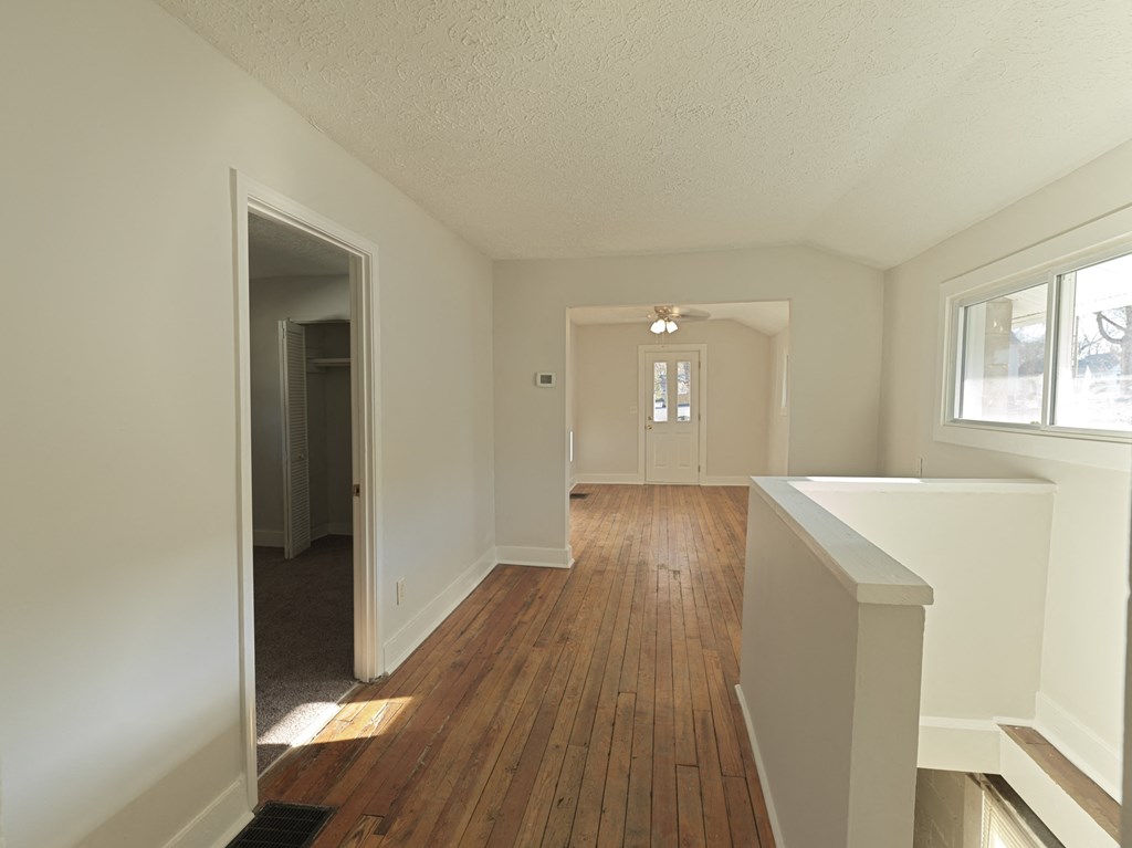 A room with wooden floors and white walls.