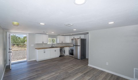 A kitchen with white cabinets and a wooden countertop.