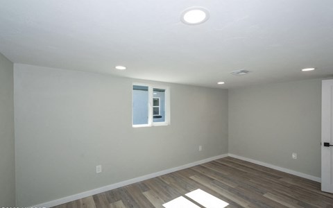 A room with a window and a door.