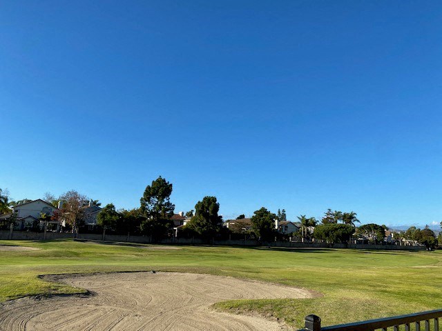 a golf course with a blue sky in the background