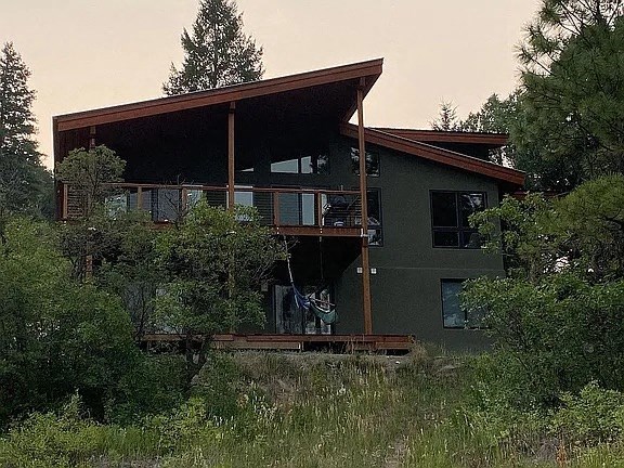 a house with a porch and a person on the balcony