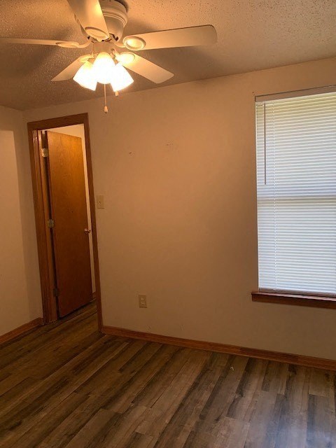 a living room with a ceiling fan and a door