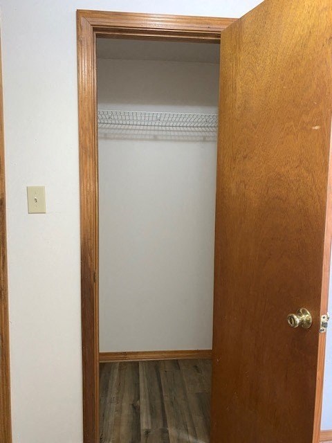 an empty room with a door to a closet