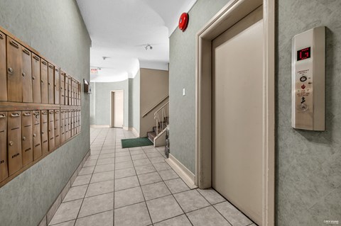 A hallway with a fire alarm on the wall.