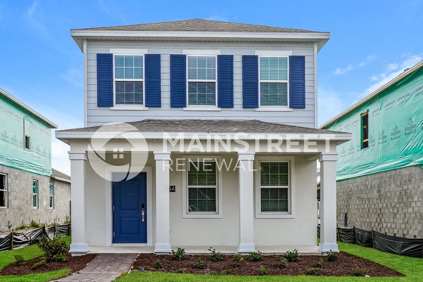 a house with blue shutters and a blue front door