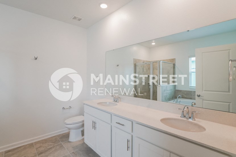 a brand new bathroom with two sinks and a toilet